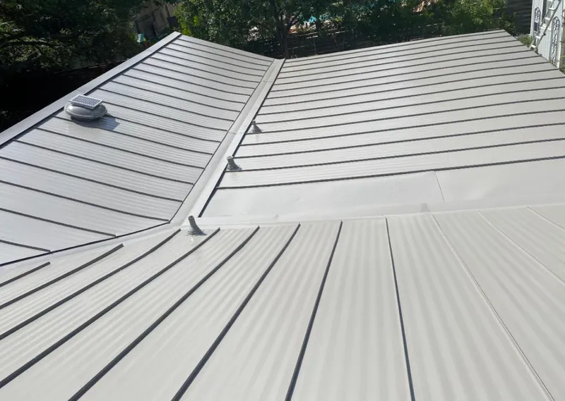Solar attic fan installed on a metal roof for Roof Ventilation in Des Moines